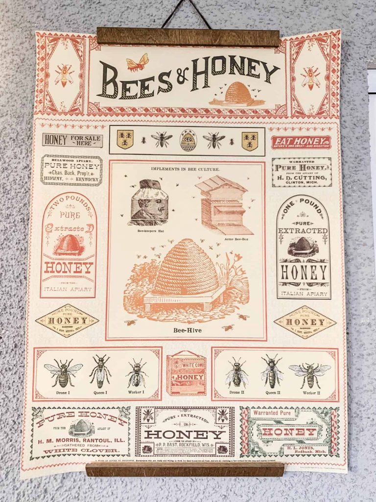 bees and honey poster hanging on the wall.