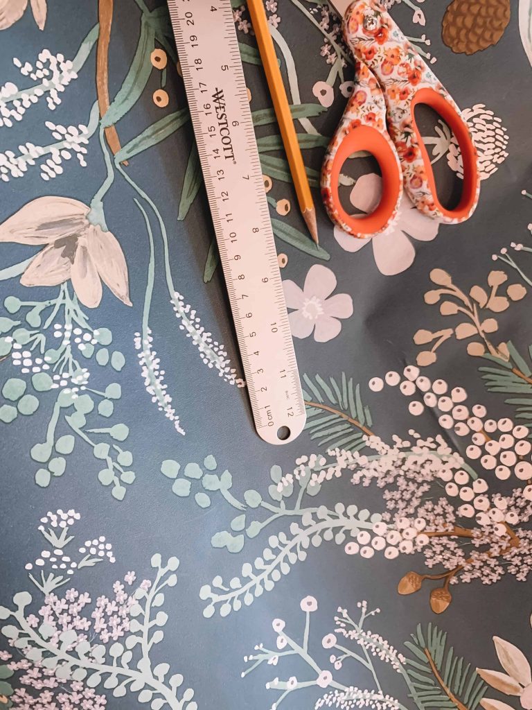 green, blue, and white juniper forest rifle paper co wallpaper and scissors, pencil, and ruler