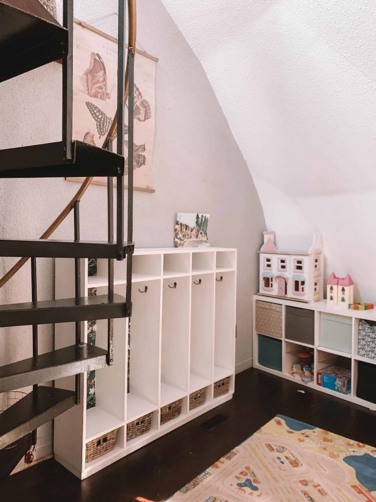 winding metal staircase with cubbies and toys